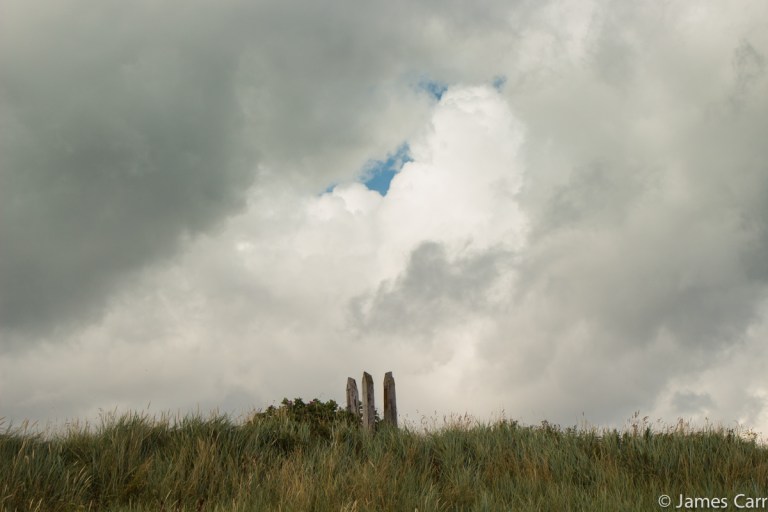 Three stakes and a hole in the clouds. Termonfeckin Beach, Co. Louth